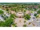 Aerial view of the Regal Palms clubhouse, fountain, and parking lot, with condos and trees surrounding at 244 Capri Dr, Davenport, FL 33897