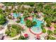 Aerial view of the Regal Palms resort pool area featuring several pools, palm trees, and lounge chairs at 244 Capri Dr, Davenport, FL 33897