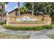 Regal Palms community sign featuring lush landscaping with multi-story condos in the background at 244 Capri Dr, Davenport, FL 33897