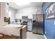 Well-lit kitchen featuring stainless steel appliances, white cabinets, and light countertops at 244 Capri Dr, Davenport, FL 33897