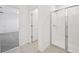 Bright bathroom featuring a glass-enclosed shower, tile flooring, and neutral color palette at 3158 Viceroy Ct, Poinciana, FL 34759