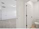 View of a half bathroom and bedroom featuring plush carpeting and neutral tones at 3158 Viceroy Ct, Poinciana, FL 34759