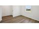 A bright bedroom with wood flooring, window and neutral walls provides a serene and inviting space at 3158 Viceroy Ct, Poinciana, FL 34759