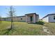 A backyard showcasing the covered patio and lush landscaping at 3158 Viceroy Ct, Poinciana, FL 34759