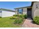Close-up of a home's exterior showcasing manicured landscaping and a brick walkway at 3158 Viceroy Ct, Poinciana, FL 34759