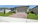 Well-maintained single-story home with a brick driveway and neat landscaping at 3158 Viceroy Ct, Poinciana, FL 34759