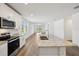 Well-lit kitchen showcasing granite island, stainless steel appliances, and a seamless flow to the living space at 3158 Viceroy Ct, Poinciana, FL 34759