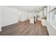 Spacious living area with hardwood floors offering a view into the modern kitchen at 3158 Viceroy Ct, Poinciana, FL 34759