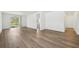 Spacious living room with wood flooring, neutral paint, and sliding door to the backyard at 3158 Viceroy Ct, Poinciana, FL 34759