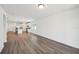 Open-concept living space with hardwood floors connecting the living room and kitchen at 3158 Viceroy Ct, Poinciana, FL 34759