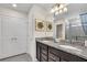 Bathroom with double sinks, granite countertops, and decorative wall art at 1870 Summer Dr, Davenport, FL 33897