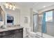 Bright bathroom featuring granite countertops, modern fixtures, and tiled shower with glass door at 1870 Summer Dr, Davenport, FL 33897