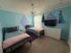 bedroom features themed decorations, two beds with colorful bedding and a chandelier at 1870 Summer Dr, Davenport, FL 33897