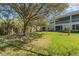 Serene backyard view with mature trees and green lawn in a peaceful community at 524 Hockendale Cv, Sanford, FL 32771