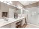 Modern bathroom featuring a double sink vanity, tile flooring, and glass-enclosed shower at 524 Hockendale Cv, Sanford, FL 32771