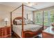 Elegant main bedroom with a four-poster bed, ceiling fan and large bright window at 524 Hockendale Cv, Sanford, FL 32771