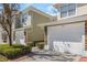 Townhome featuring attached garage, stone accents, and manicured landscaping at 524 Hockendale Cv, Sanford, FL 32771