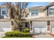 Charming townhome exterior with stone accents, attached garage, and well-maintained landscaping at 524 Hockendale Cv, Sanford, FL 32771