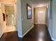 Hallway featuring hardwood floors, fresh paint, and doors to the bathroom and entrance at 524 Hockendale Cv, Sanford, FL 32771