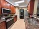 Well-lit kitchen featuring granite counters, stainless steel appliances, and ample cabinet space at 524 Hockendale Cv, Sanford, FL 32771