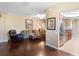 Inviting living room with hardwood floors, a plush sofa, and stainless steel refrigerator at 524 Hockendale Cv, Sanford, FL 32771