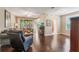 Spacious living room with hardwood floors and a screened in porch visible through sliding glass doors at 524 Hockendale Cv, Sanford, FL 32771