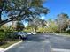 A well-maintained parking lot with mature trees providing shade at 524 Hockendale Cv, Sanford, FL 32771