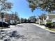 A quiet street view showing well-maintained townhomes with manicured lawns and tree-lined sidewalks at 524 Hockendale Cv, Sanford, FL 32771