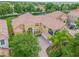 Luxury two-story home with tile roof, large driveway, and lush landscaping at 334 Chadwick Dr, Davenport, FL 33837