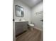 Bathroom featuring gray vanity, updated fixtures, and luxury vinyl flooring at 2806 Bonneville Dr, Orlando, FL 32826