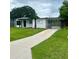 Charming single-story home with well-manicured lawn, carport, and freshly painted exterior at 2806 Bonneville Dr, Orlando, FL 32826