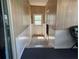 Bright entryway featuring paneled walls, white trim, and a door leading outside at 550 Saint Johns Rd, Tavares, FL 32778