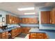 Spacious kitchen with ample wood cabinetry, blue countertops, and modern appliances at 550 Saint Johns Rd, Tavares, FL 32778