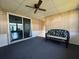 Cozy lanai featuring a ceiling fan, carpeted floor and access to the backyard via sliding glass door at 550 Saint Johns Rd, Tavares, FL 32778