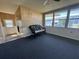 Cozy sunroom featuring bright, natural light, carpeting, and access to the backyard at 550 Saint Johns Rd, Tavares, FL 32778
