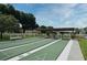 Well-maintained shuffleboard courts in a serene community setting with white picket fences at 550 Saint Johns Rd, Tavares, FL 32778