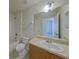 Cozy bathroom featuring a single sink vanity and a shower-tub combo at 2543 Old Kent Cir, Kissimmee, FL 34758
