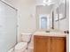 Clean bathroom featuring a glass-enclosed shower, a toilet, and a vanity with a sink and mirror at 2543 Old Kent Cir, Kissimmee, FL 34758