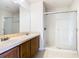 Bathroom with double sink vanity, and glass-enclosed shower at 2543 Old Kent Cir, Kissimmee, FL 34758