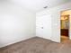 Bedroom with neutral walls, plush carpeting, and an ensuite bathroom at 2543 Old Kent Cir, Kissimmee, FL 34758