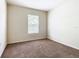 Bedroom featuring a window with natural light and carpeted floor at 2543 Old Kent Cir, Kissimmee, FL 34758