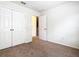 Bedroom with neutral walls, plush carpeting, and a double door closet at 2543 Old Kent Cir, Kissimmee, FL 34758
