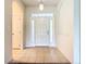 Bright entryway featuring neutral tiled floors, arched doorways, and a glass-accented front door at 2543 Old Kent Cir, Kissimmee, FL 34758