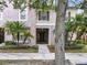Inviting two-story townhome with tropical landscaping and a welcoming front entrance at 2543 Old Kent Cir, Kissimmee, FL 34758