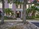 Inviting two-story townhome with tropical landscaping and a welcoming front entrance at 2543 Old Kent Cir, Kissimmee, FL 34758