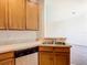 Galley-style kitchen featuring wooden cabinets, laminate countertops, and a black dishwasher at 2543 Old Kent Cir, Kissimmee, FL 34758