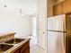 Functional kitchen with stainless steel refrigerator and a view of the dining area and patio door at 2543 Old Kent Cir, Kissimmee, FL 34758