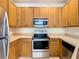 Functional kitchen featuring wood cabinets, stainless steel appliances, and ample counter space at 2543 Old Kent Cir, Kissimmee, FL 34758
