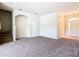 Open living room with plush carpeting, leading to staircase and front entrance at 2543 Old Kent Cir, Kissimmee, FL 34758