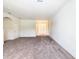 Spacious living room with neutral carpeting, an arched entryway, and a front door view at 2543 Old Kent Cir, Kissimmee, FL 34758